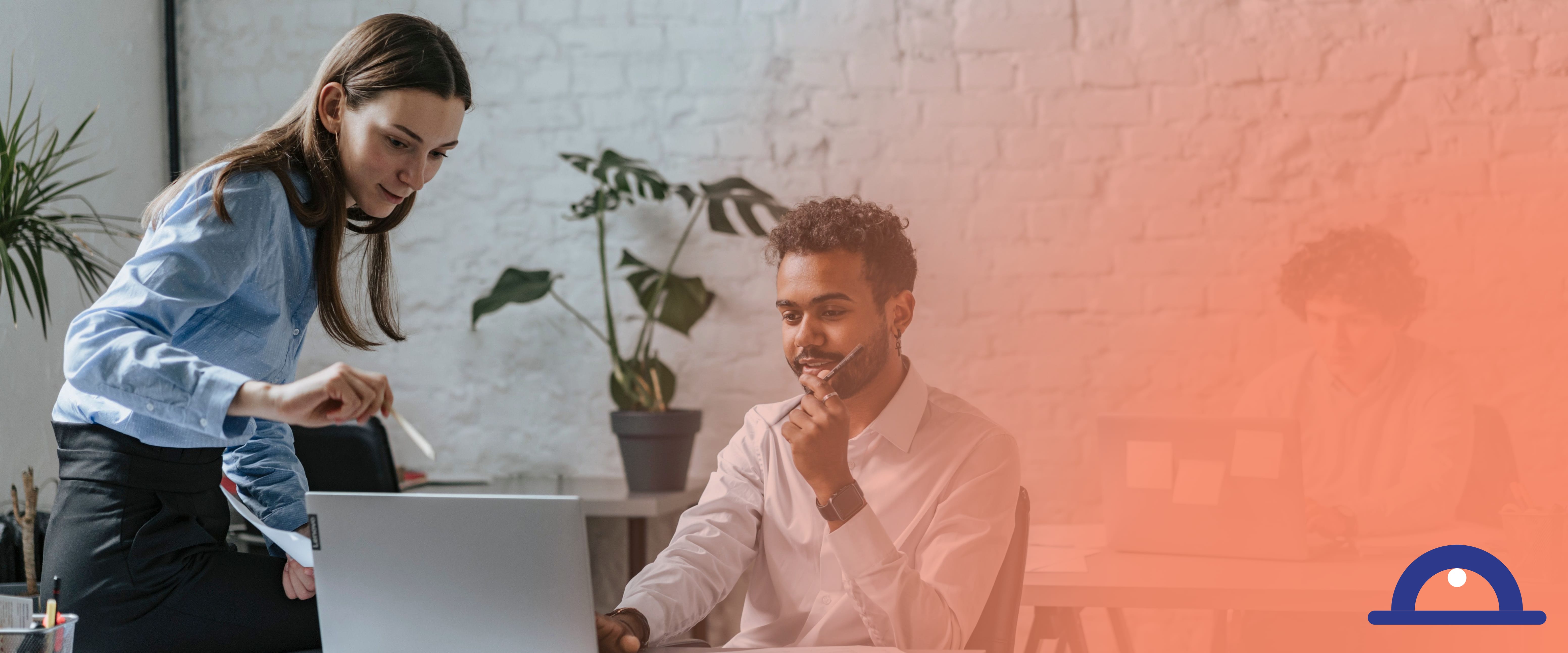 A manager and an employee reviewing a leave carry-over policy on a laptop